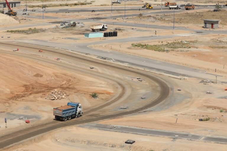 Aerial shot of a construction site in Konza, Kenya, showing dirt roads and machinery