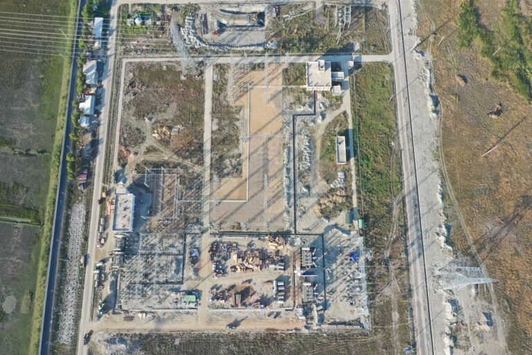 Aerial shot of an industrial construction site in Golbania, showcasing structures and landscape