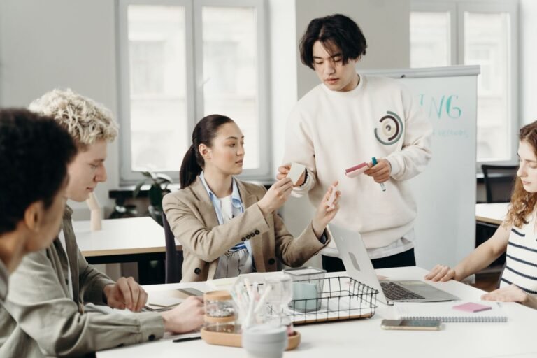 A diverse group of young adults collaborating in a modern office setting, discussing a project