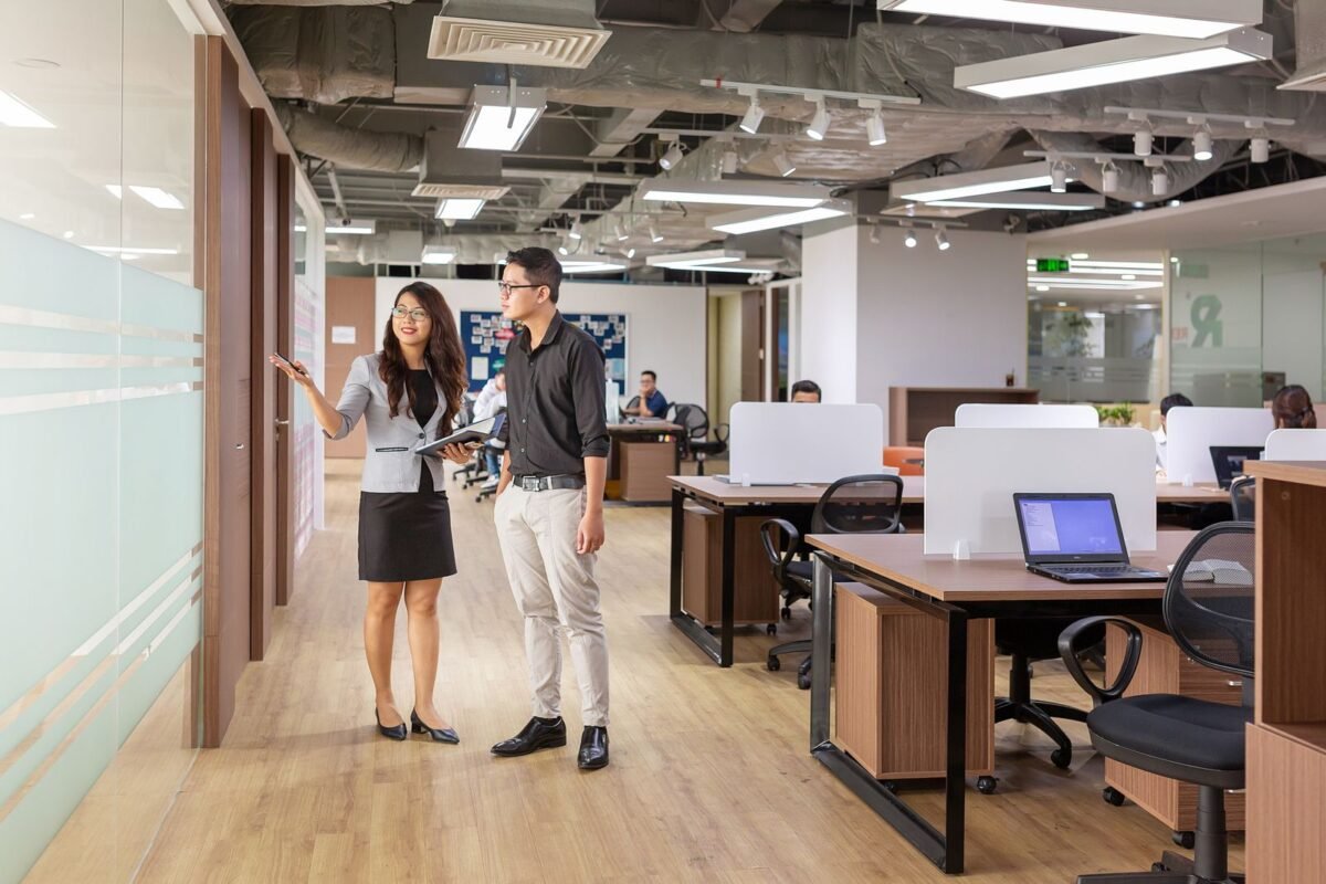 Sublease Term Shorter Than the Head Lease in Vietnam Industrial Parks: What Happens When the Head Lease Expires First 1 Asian professionals discussing in a contemporary office setting with open workspaces