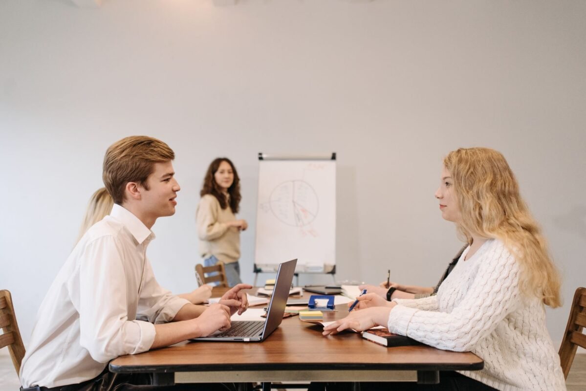 Bilingual Land Sublease Contracts in Vietnam Industrial Parks: Which Language Prevails in a Conflict 1 Business meeting with colleagues discussing a project using a laptop and flip chart