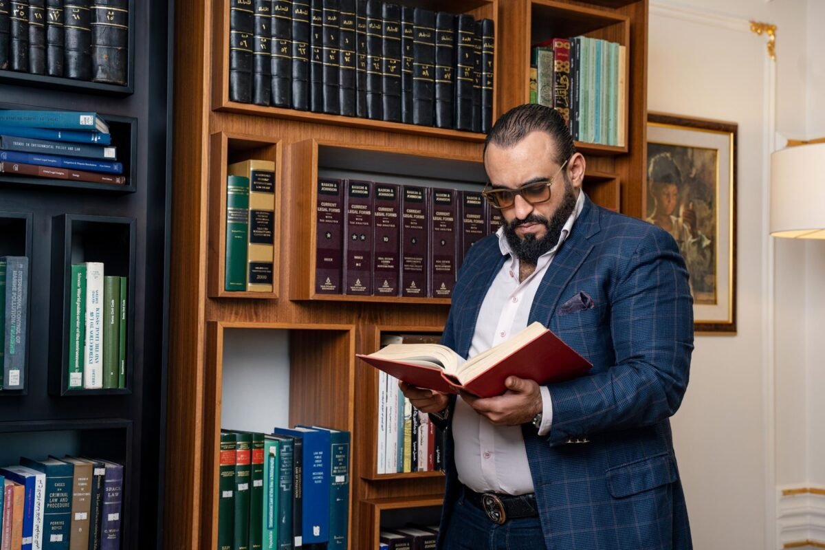 A Bearded Man in a Suit Reading a Book