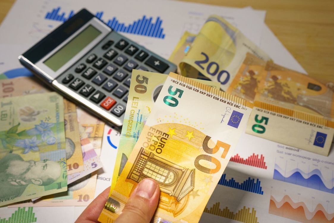 Euro and Romanian Lei currency with calculator on a financial desk setup