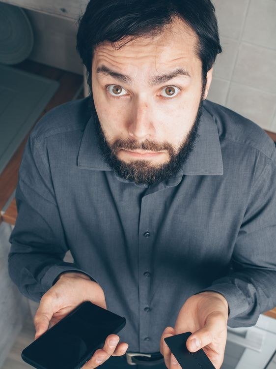 Bearded Man in Gray Long Sleeves Holding a Smartphone