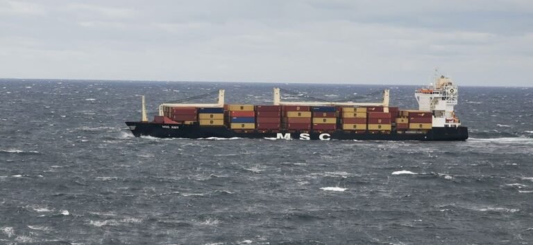 A large cargo vessel transporting containers in the choppy North Sea off the coast of Denmark.