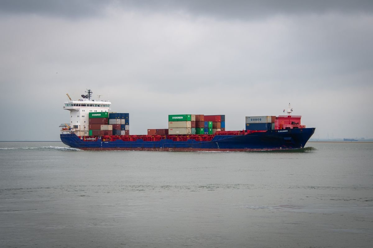 Import duty refund after exporting products abroad — white and blue cargo ship sailing on the sea, no people