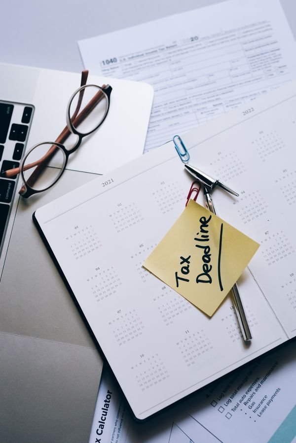 Calendar with a deadline reminder note on a desk (illustrative)