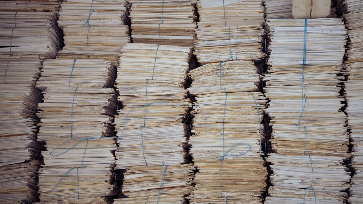 Late project implementation reports: fine levels 1 A pile of paperwork on a desk — illustrating late report filing and penalties