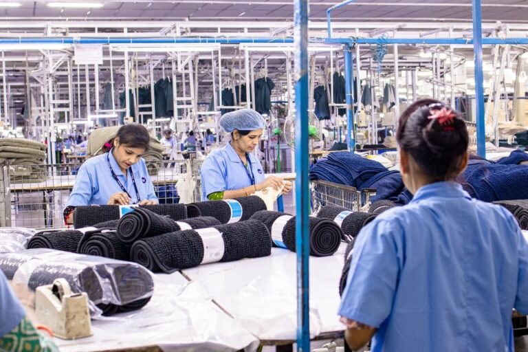 Workers collaborating inside an industrial manufacturing plant