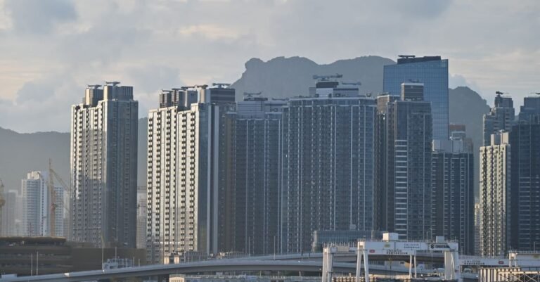 Hong Kong urban skyline with high-rise buildings against mountains, illustrating the Hong Kong vs Vietnam minimum wage comparison