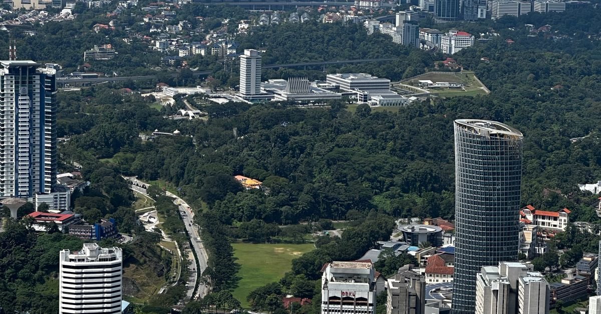 Aerial view of the Kuala Lumpur cityscape on a clear day, illustrating the Malaysia vs Vietnam minimum wage comparison