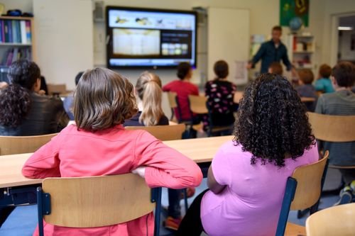 Young children playing with blocks in a bright preschool classroom — illustrating private preschool opening