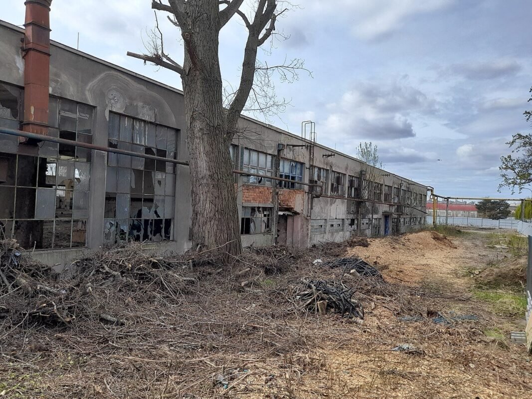 Factory building exterior, illustrating a partial investment project transfer