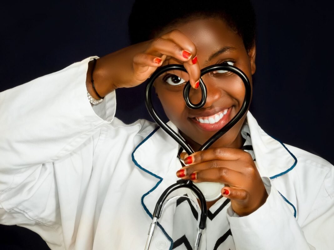 Woman in lab coat holding stethoscope