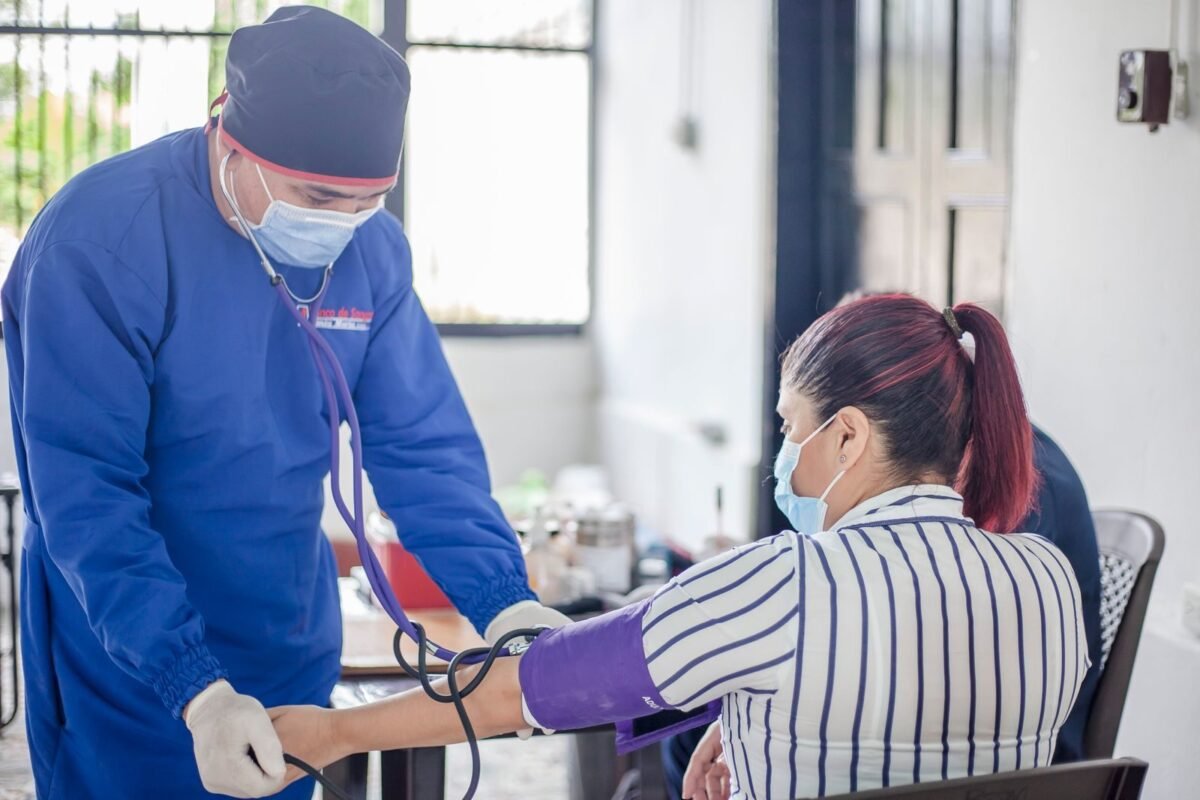 Medical practitioner checking blood pressure of patient