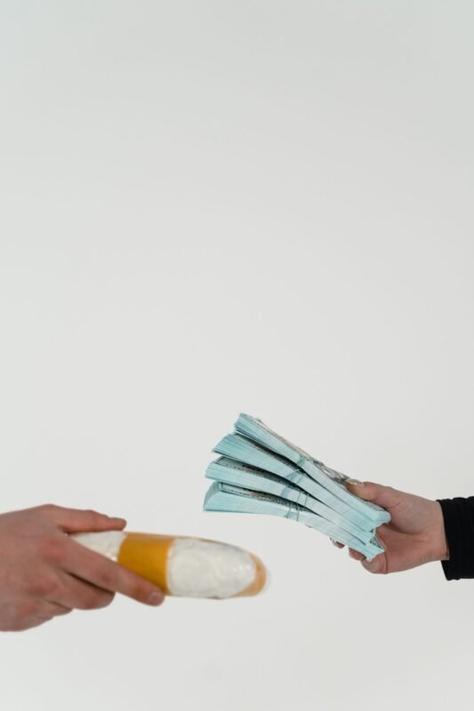 Hands exchanging cash and package