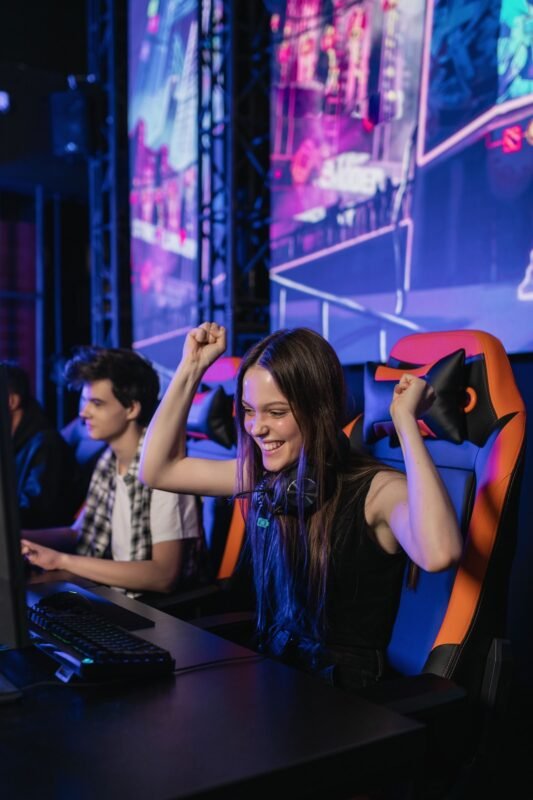 Girl smiling sitting on gaming chair