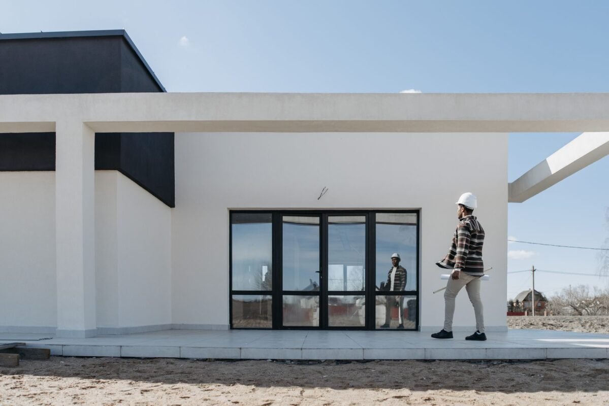 Rent Money from Abroad: 2 Lawful Ways & Rental Tax 1 Architect evaluating modern house exterior