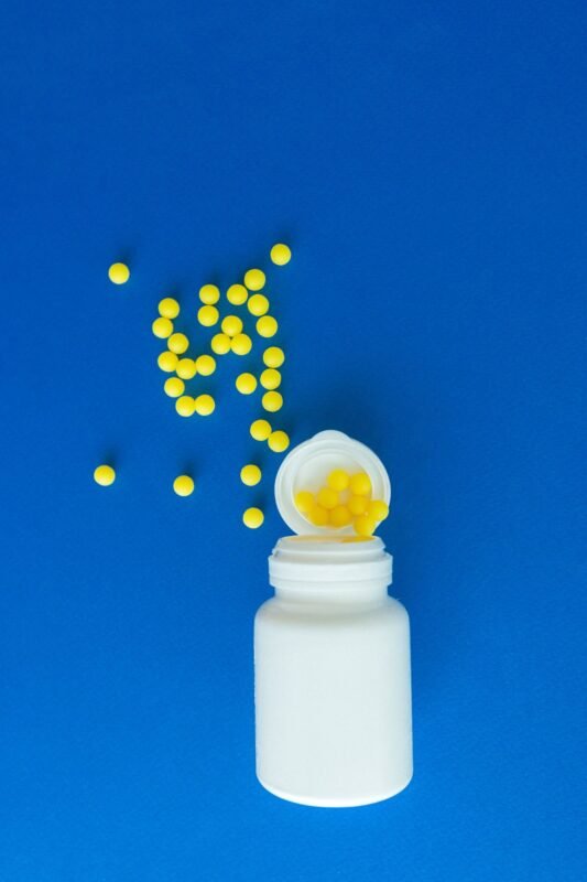 Pharmacist holding medicine bottles