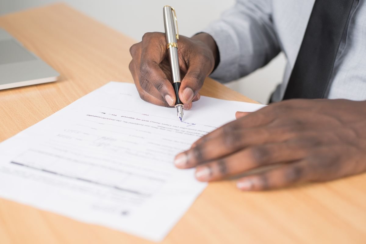 Assigning an industrial park land sublease contract to another investor 1 Person Holding Gray Twist Pen and White Printer Paper on Brown Wooden Table