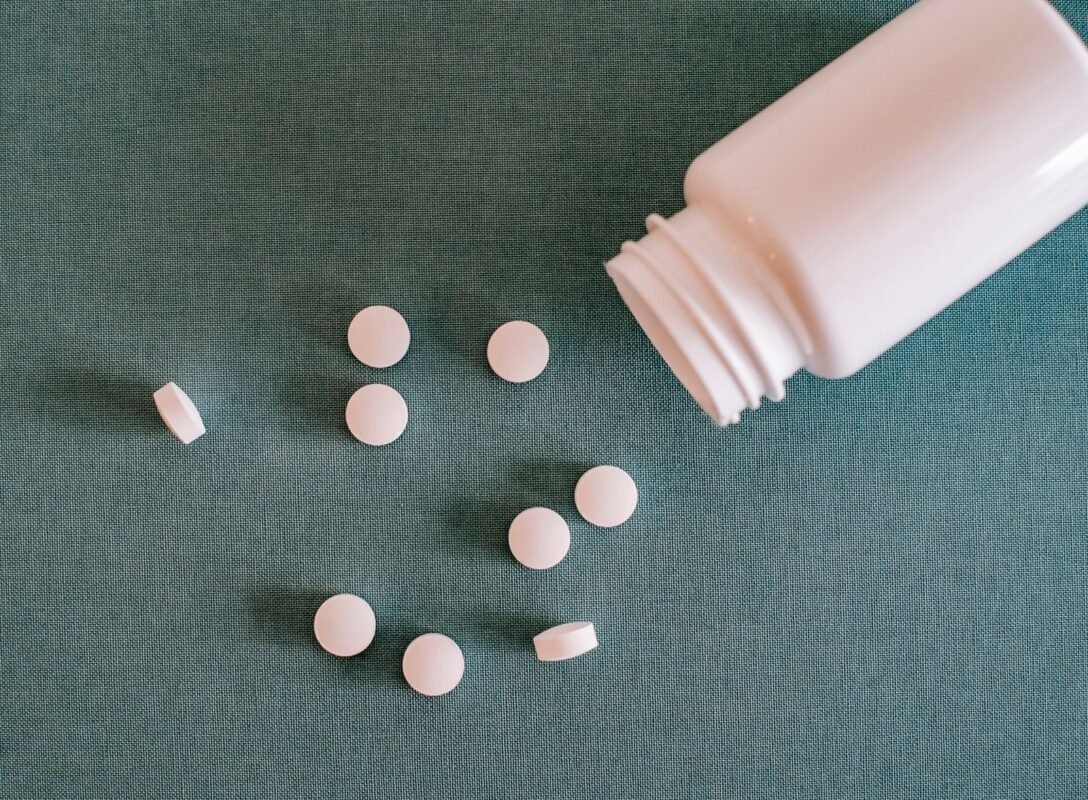 White pills spilling from a medicine bottle