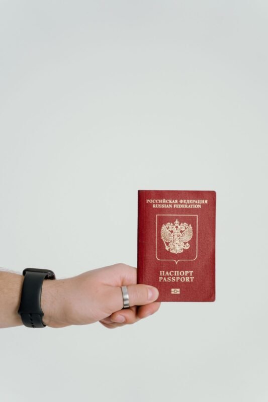 Renewing Residence Cards While the Company Is Suspended or Has Moved Its Head Office: Handling Experts' Residence Files 1 Hand holding a passport