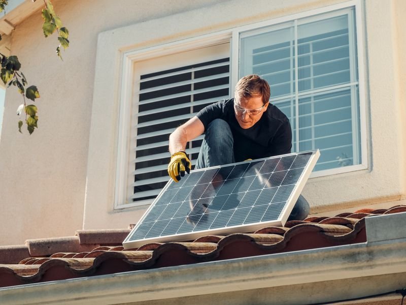 Installing solar panels on a rooftop