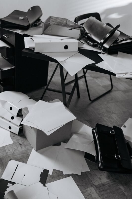 Office desk covered with papers and files